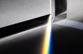 Triangular Prism dispersing sun beam splitting into a spectrum on white background