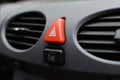Triangular red hazard flasher button inside car interior