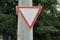 triangular road sign on a pillar give way