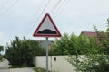 Triangular road sign speed bump on a metal pillar