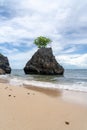 Triangular rock in the ocean on Bingin Beach, Bali - Indonesia Royalty Free Stock Photo