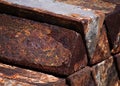 Triangular rusted Ingots of a heavy metal