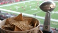 Triangular rye chips snack bowl in sports setting during a football game Royalty Free Stock Photo