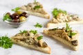 Triangular sandwiches with summer mushrooms cooked with cream and herbs served with olives.