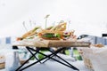 Triangular shaped sandwich with ham, vegetables and mayonnaise on a wooden platter. Summer outdoor event menu