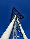 Triangular sign on a big three leg steel pole