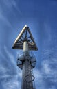 Triangular sign on a high steel pole