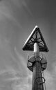 Triangular sign on a high steel pole