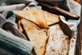 Triangular slices of toasted white bread with a soft texture inside and a crisp crust on the outside on a rusty metal background Royalty Free Stock Photo