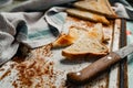 Triangular slices of toasted white bread with a soft texture inside and a crisp crust on the outside on a rusty metal