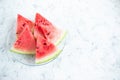 Triangular slices of watermelon on a light concrete background. Flat lay, top view