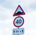 Triangular Traffic Road sign artificial unevenness after 50 m for forced speed reduction with speed limit sign 40