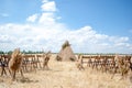 Triangular wooden arch in a golden mown field. Venue for a wedding ceremony in the countryside. Rustic style Royalty Free Stock Photo