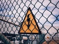 high voltage warning sign on a high-voltage substations mesh fence Royalty Free Stock Photo