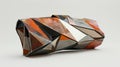 A triangularshaped clutch with a mix of sharp and curved lines in abstract patterns Royalty Free Stock Photo