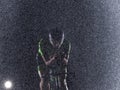 A triathlete braving the rain as he cycles through the night, preparing himself for the upcoming marathon. The blurred