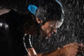 A triathlete braving the rain as he cycles through the night, preparing himself for the upcoming marathon. The blurred