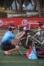 a triathlete checks his bike in transition before the start of a race