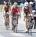 Triathlete Sarah True cycling, followed by competitors