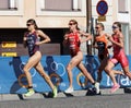 Triathlete Sarah True running, followed by competitors