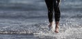 Triathlete swimmer running out of ocean finishing swim race Royalty Free Stock Photo