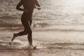 Triathlete swimmer running out of ocean finishing swim race Royalty Free Stock Photo