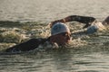 Triathletes swim on start of the Ironman triathlon competition