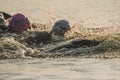 Triathletes swim on start of the Ironman triathlon competition