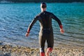 Triathlon athlete starting swimming training on lake Royalty Free Stock Photo