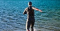Triathlon athlete starting swimming training on lake Royalty Free Stock Photo
