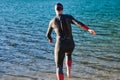 Triathlon athlete starting swimming training on lake Royalty Free Stock Photo
