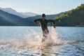 Triathlon athlete starting swimming training on lake Royalty Free Stock Photo