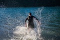Triathlon athlete starting swimming training on lake Royalty Free Stock Photo