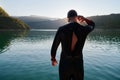 Triathlon athlete starting swimming training on lake Royalty Free Stock Photo