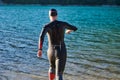 Triathlon athlete starting swimming training on lake Royalty Free Stock Photo