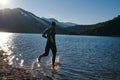 Triathlon athlete starting swimming training on lake Royalty Free Stock Photo