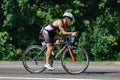 Triathlon biking man cycling on road bike at top speed on the triathlon race