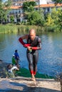 Triathlon swim bike run triathlete man training for ironman race concept. Professional cyclist, runner, swimmer. Royalty Free Stock Photo