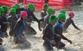 Triathlon swimmers entering open water swim stage.