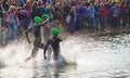 Triathlon swimmers entering open water swim stage.