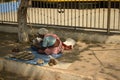 Tribal woman vendor selling insect repellent on the street