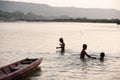 Tribe Bru Children swimming and playing in Mekong River in summer hot weather. Old tribe. Thai-Laos border. Thailand.