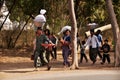 Tribe ethnic of burmese group man women children walking carry move product thing from home go to bazaar market at Bagan or Pagan