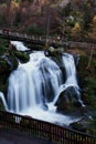 Triberg waterfall under a bridge, next to a walking path Royalty Free Stock Photo