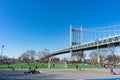 The Triborough Bridge and People Exercising around the Track and Field at Astoria Park