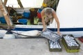 Fishermen sorting out the catch on a deck of a trawler boat Royalty Free Stock Photo