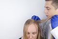A trichologist examines a girl with oily hair. Problematic scalp and increased secretion of the sebaceous glands. Hair care. Oily
