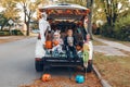 Trick o trunk. Siblings brother and sister celebrating Halloween in trunk of car. Children kids boy and baby girl celebrating