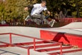 Trick on ramp. Energetic man on roller skates in motion at modern roller skate park. Roller skater doing dangerous and