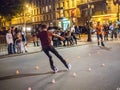 Trick skater negotiates slalom cones on a pedestrian bridge in p